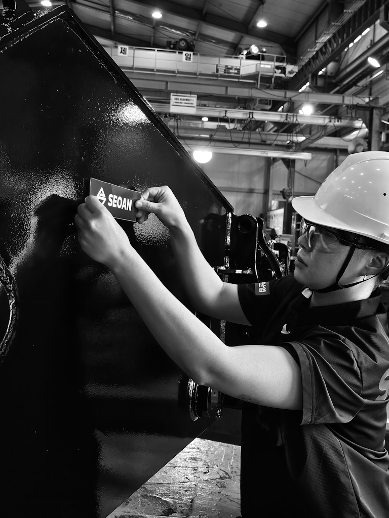 SEOAN worker applying a logo label