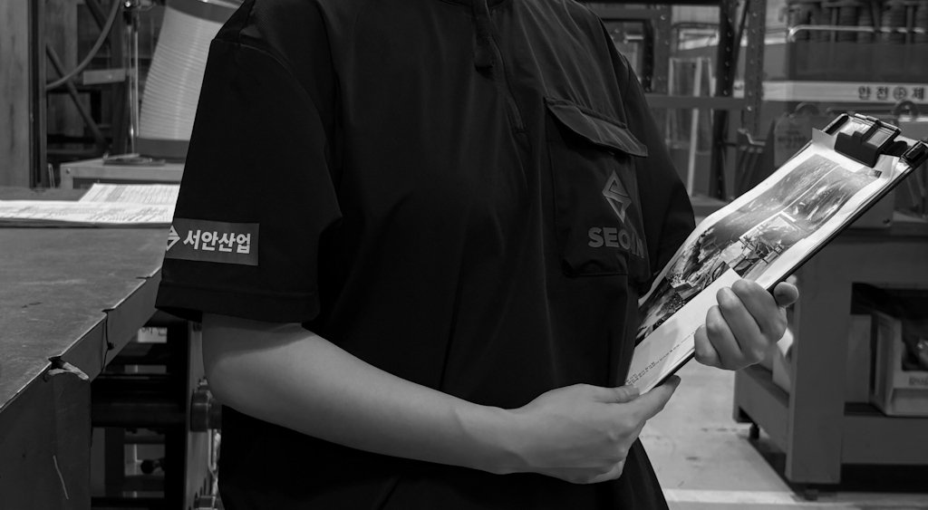 SEOAN worker holding documents
